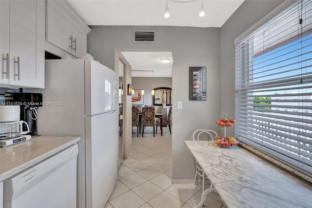 4000 NW 44th Ave Unit 405, Lauderdale Lakes, FL 33319 - kitchen featuring white cabinetry, dishwasher, and light tile patterned flooring
