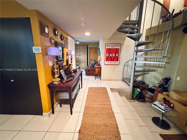 corridor with recessed lighting, stairs, baseboards, and light tile patterned flooring