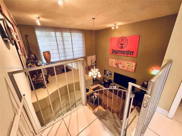 3007 NE 183rd Ln Unit 7, Aventura, FL 33160 - staircase featuring baseboards, a textured ceiling, an inviting chandelier, and tile patterned floors