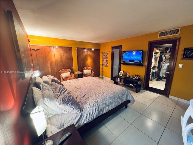 3007 NE 183rd Ln Unit 7, Aventura, FL 33160 - bedroom featuring a walk in closet, visible vents, tile patterned flooring, baseboards, and a closet