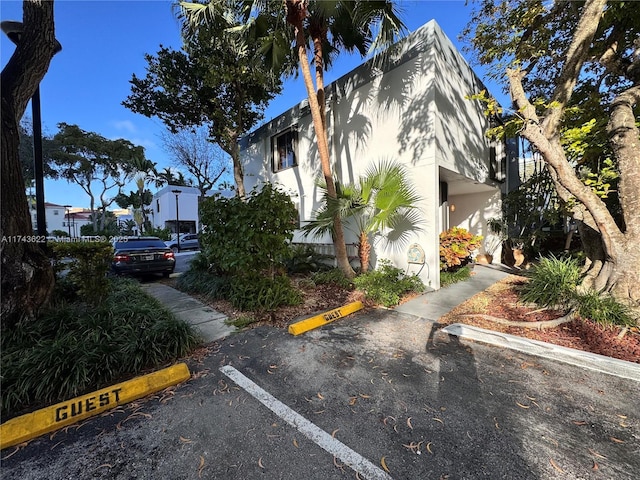 3007 NE 183rd Ln Unit 7, Aventura, FL 33160 - view of side of home with stucco siding and uncovered parking