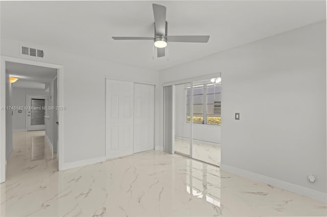 unfurnished bedroom featuring ceiling fan and a closet