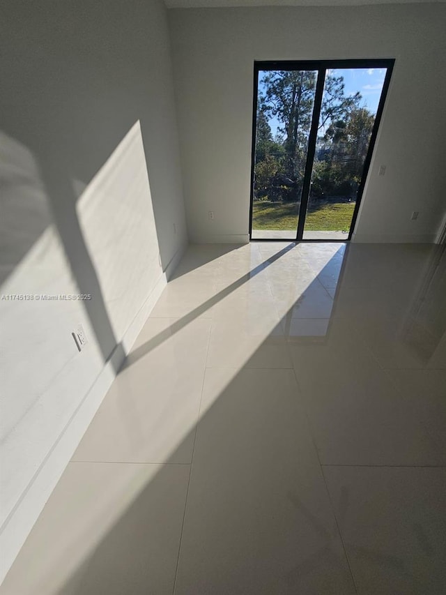 spare room with tile patterned floors