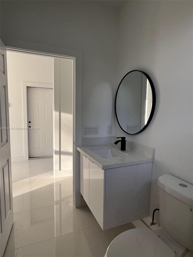 bathroom featuring vanity, toilet, and tile patterned flooring