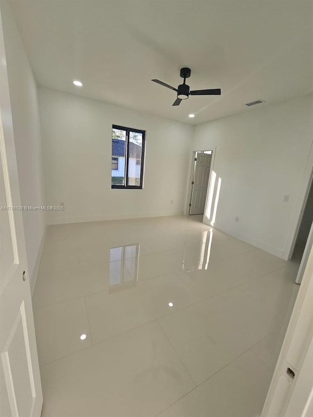 tiled empty room with ceiling fan