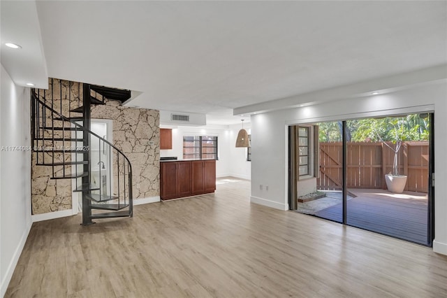 unfurnished living room with light hardwood / wood-style floors