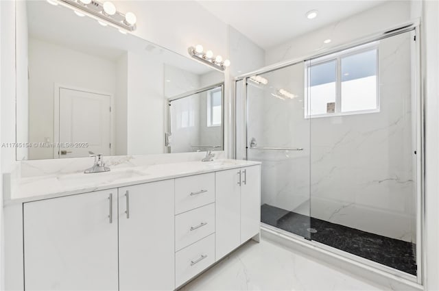 bathroom with vanity and a shower with shower door