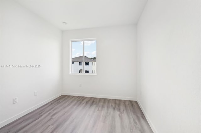 spare room with light wood-type flooring