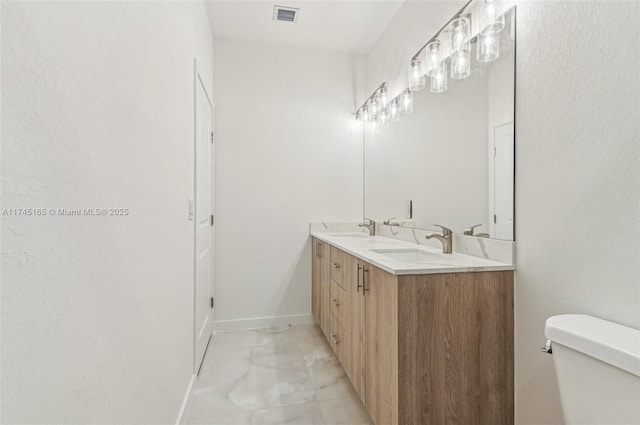 bathroom featuring vanity and toilet