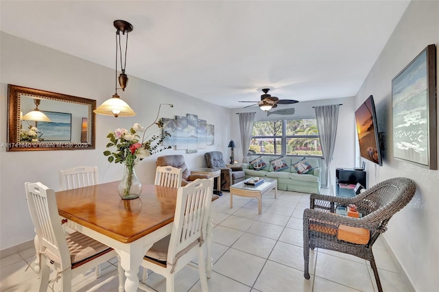 tiled dining space with ceiling fan