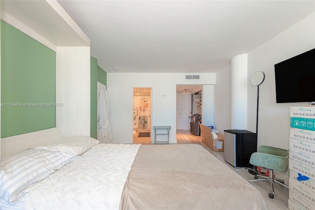 bedroom featuring refrigerator