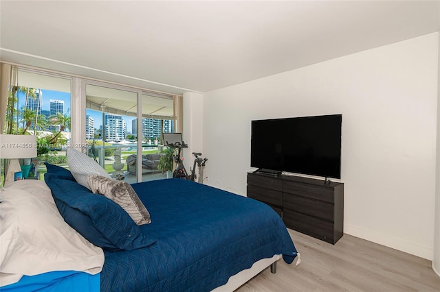 bedroom featuring access to outside and light wood-type flooring