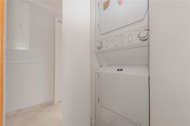 clothes washing area with laundry area, baseboards, ornamental molding, electric panel, and stacked washer and clothes dryer