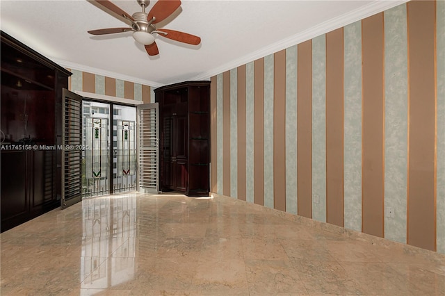 interior space with ornamental molding, a ceiling fan, and wallpapered walls