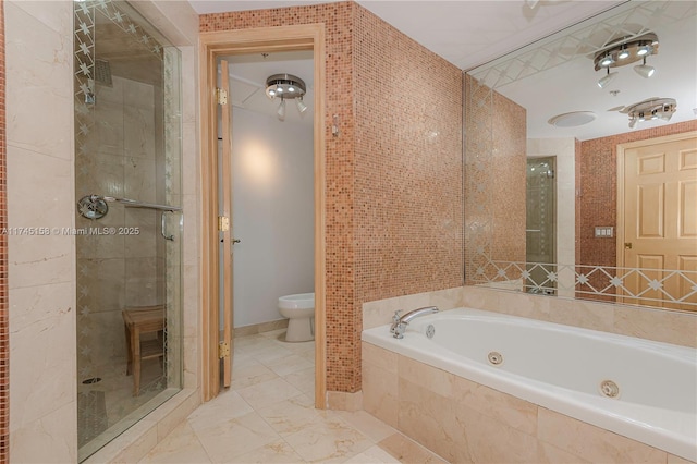 bathroom featuring marble finish floor, toilet, a shower stall, a jetted tub, and baseboards