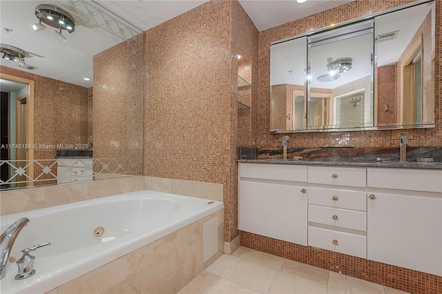 bathroom featuring a sink, visible vents, tile walls, tile patterned floors, and double vanity