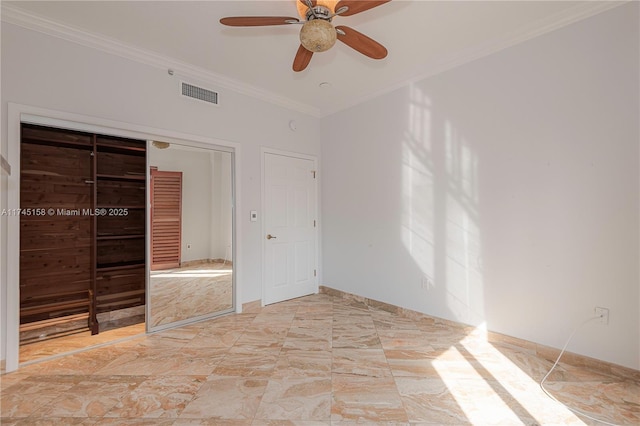 unfurnished bedroom with crown molding, visible vents, ceiling fan, and a closet