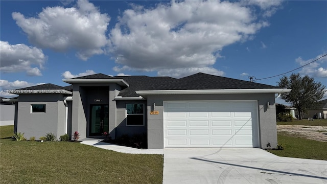 view of front of property featuring a garage and a front yard