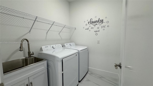 washroom with cabinets, separate washer and dryer, and sink