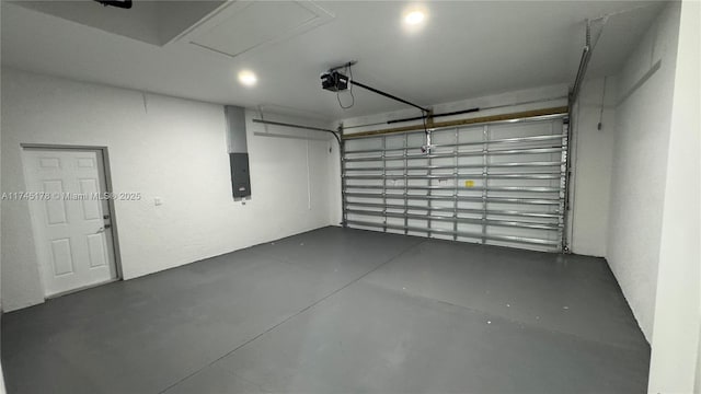 garage with a garage door opener and electric panel