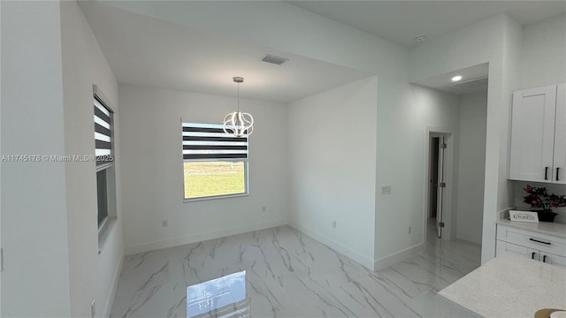 unfurnished dining area with a notable chandelier