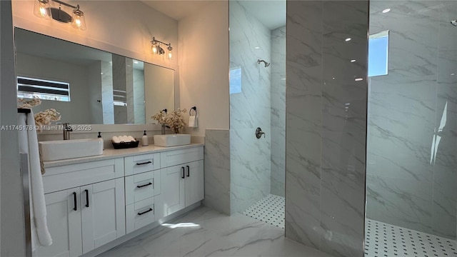 bathroom with vanity and a tile shower