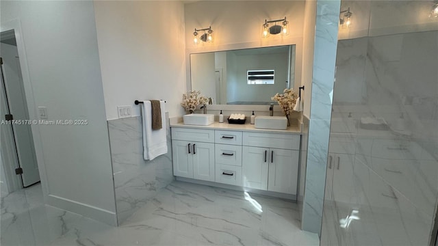 bathroom with vanity, a shower with door, and tile walls