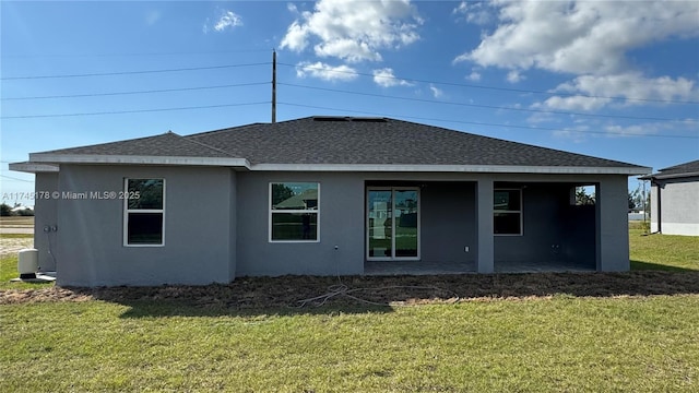 rear view of property with a yard