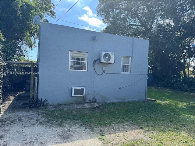 view of property exterior with ac unit and a yard