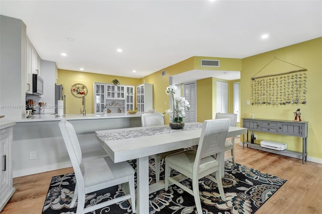 dining space with light hardwood / wood-style floors