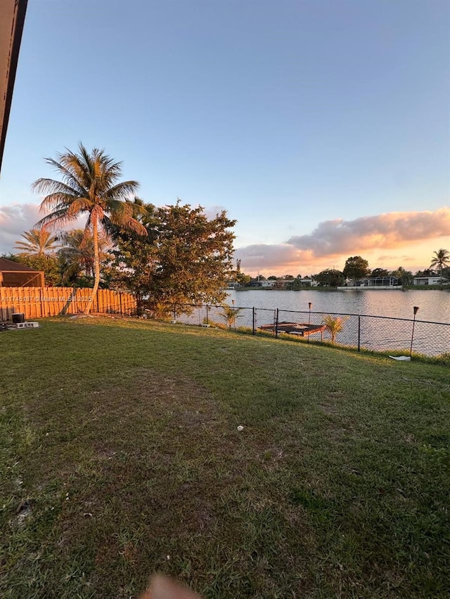 yard at dusk with a water view