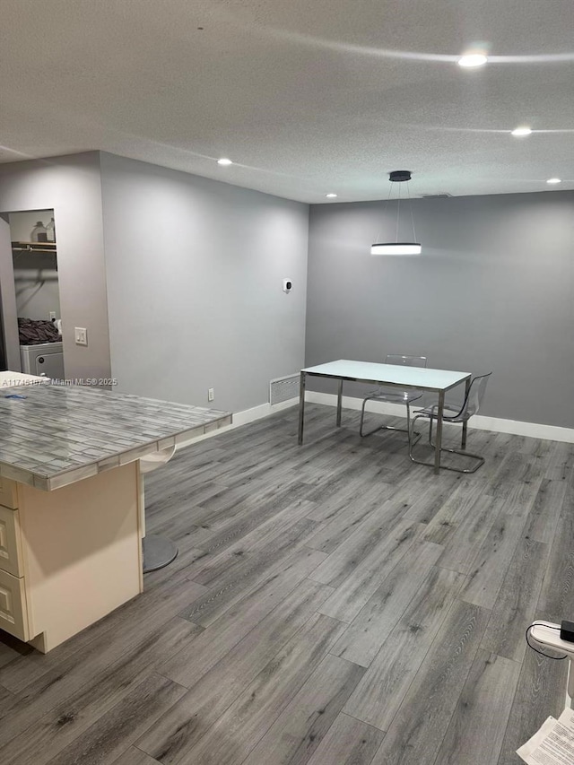 playroom with light hardwood / wood-style flooring and a textured ceiling