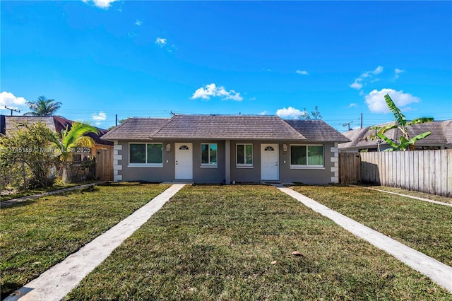 ranch-style home with a front lawn