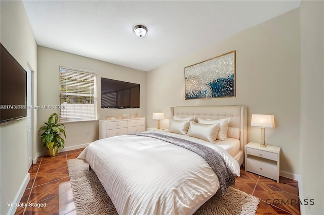 bedroom featuring baseboards