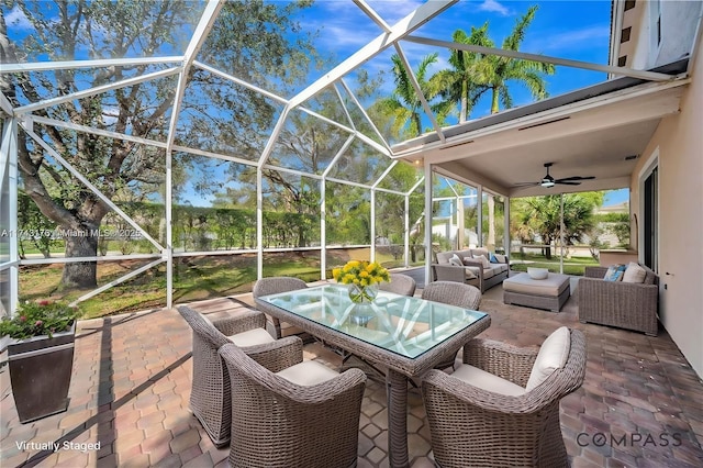 sunroom featuring ceiling fan, an outdoor living space, and outdoor dining area