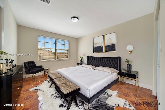 bedroom featuring visible vents and baseboards
