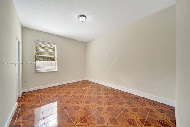 spare room with baseboards