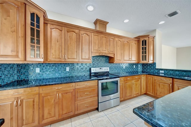kitchen featuring dark stone countertops, light tile patterned floors, stainless steel electric stove, and visible vents