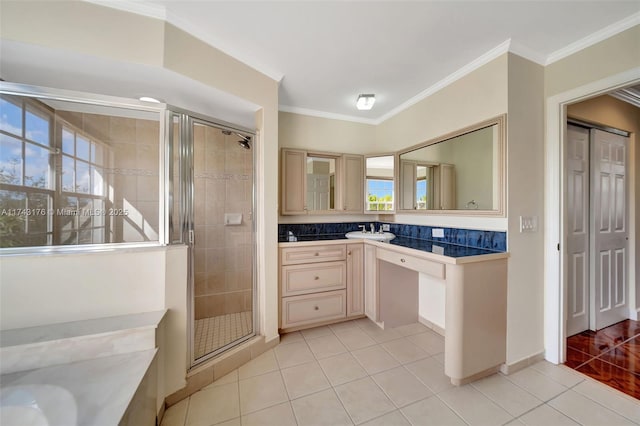 bathroom featuring ornamental molding, a stall shower, tile patterned flooring, and vanity