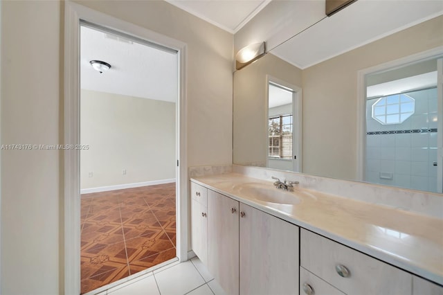 bathroom featuring ornamental molding, tile patterned flooring, and vanity
