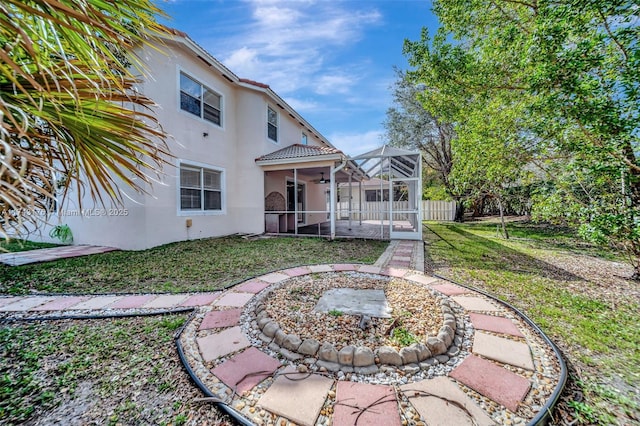 back of property featuring fence, a patio, a lawn, ceiling fan, and stucco siding