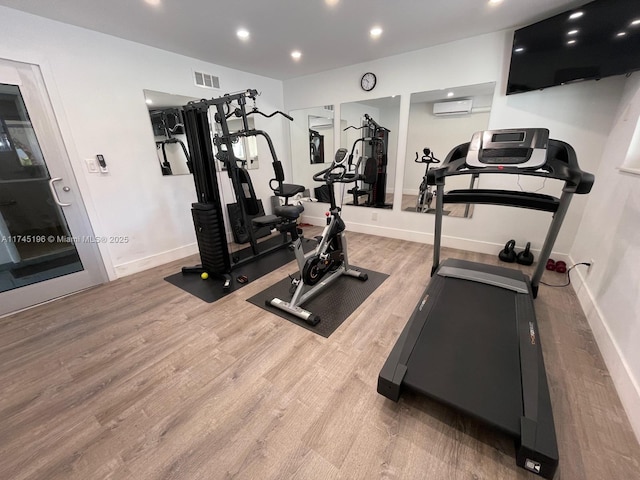 3181 S Ocean Dr Unit 107, Hallandale Beach, FL 33009 - exercise room with wood finished floors, recessed lighting, and a wall mounted AC