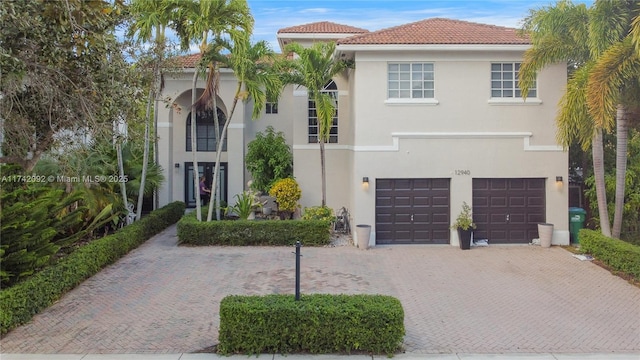 mediterranean / spanish home with a garage