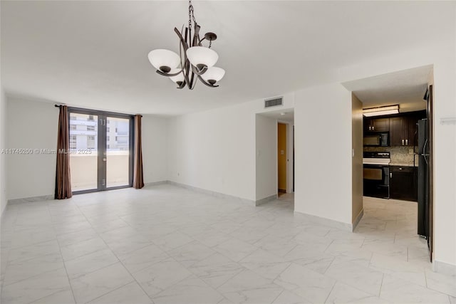 spare room with marble finish floor, baseboards, visible vents, and a chandelier