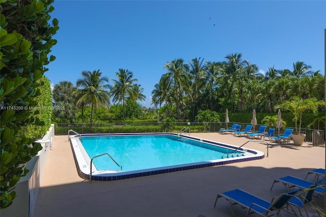 pool featuring a patio and fence