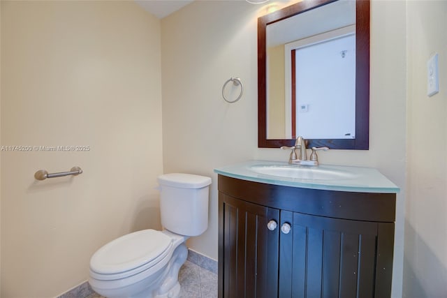 bathroom with baseboards, vanity, and toilet