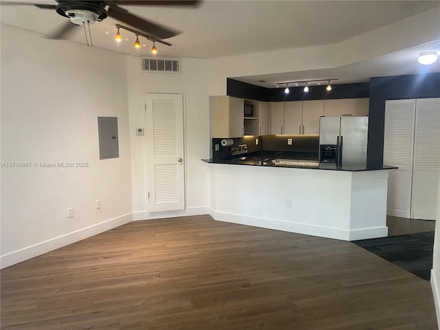 kitchen featuring dark countertops, visible vents, electric panel, a peninsula, and stainless steel fridge with ice dispenser