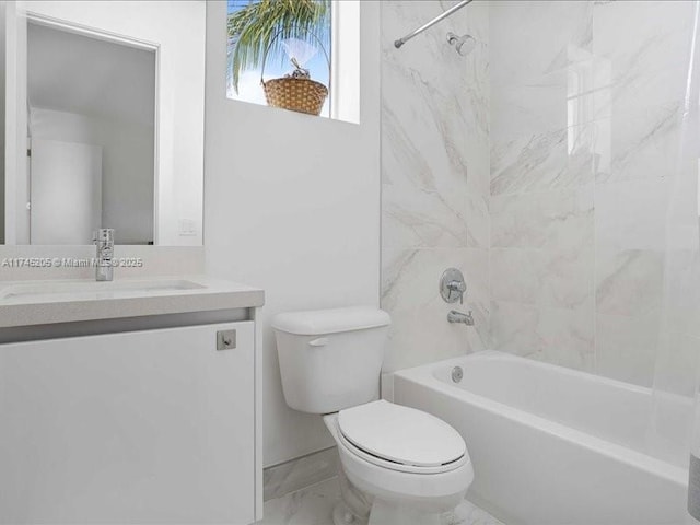 full bathroom with vanity, tiled shower / bath combo, and toilet