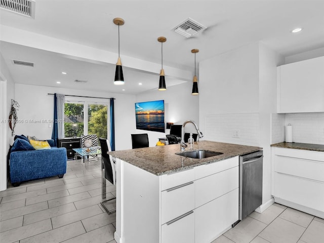 kitchen featuring pendant lighting, sink, white cabinets, stainless steel dishwasher, and kitchen peninsula