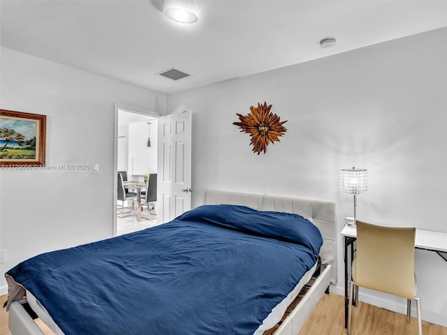 bedroom with hardwood / wood-style flooring